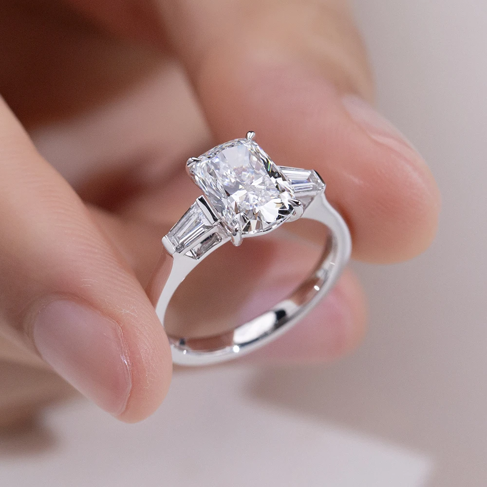 cushion cut moissanite ring, three stone engagement ring, baguette side stone ring, white gold plated ring USA, lab grown diamond alternative, luxury engagement ring for women, moissanite jewelry UK, classic bridal ring
