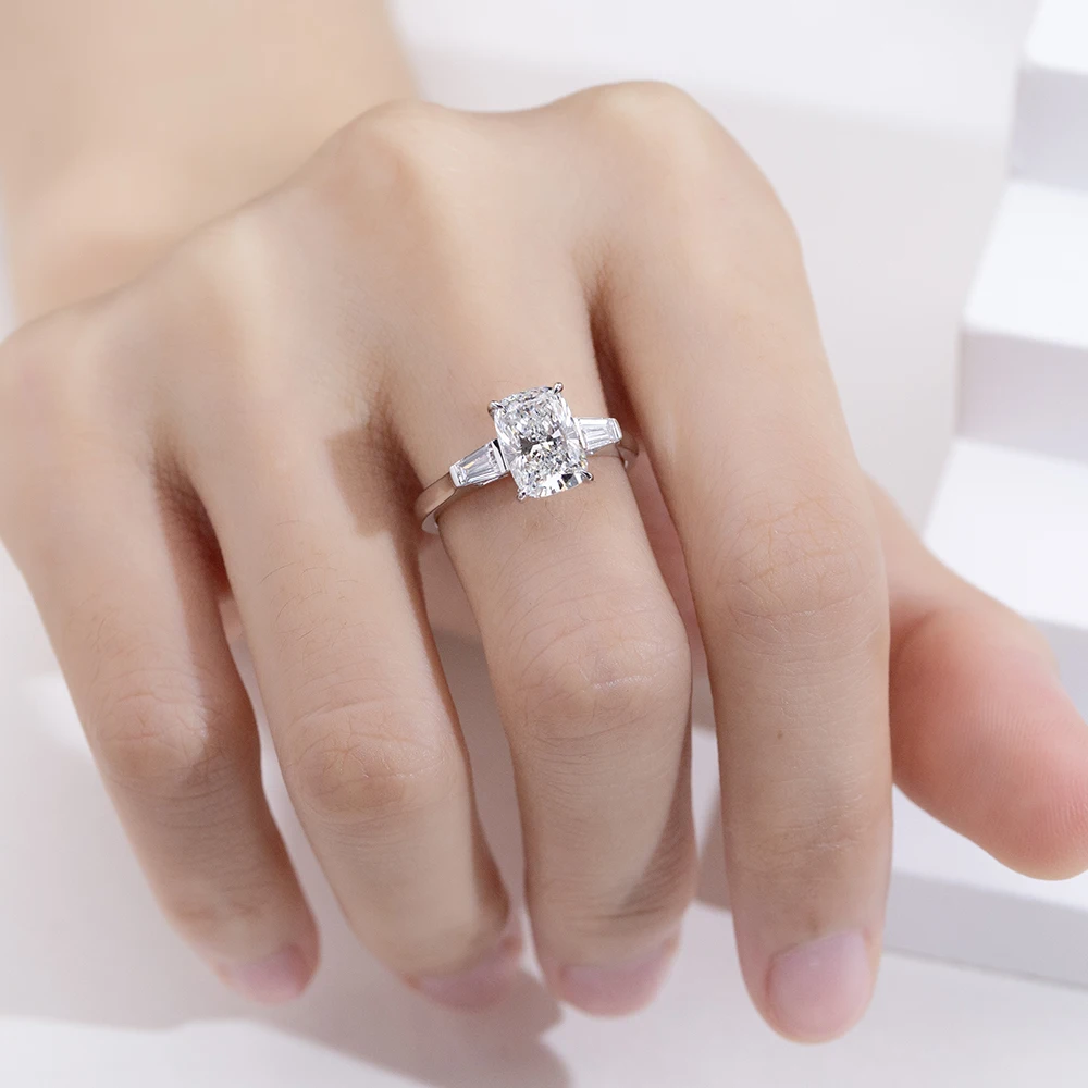 cushion cut moissanite ring, three stone engagement ring, baguette side stone ring, white gold plated ring USA, lab grown diamond alternative, luxury engagement ring for women, moissanite jewelry UK, classic bridal ring
