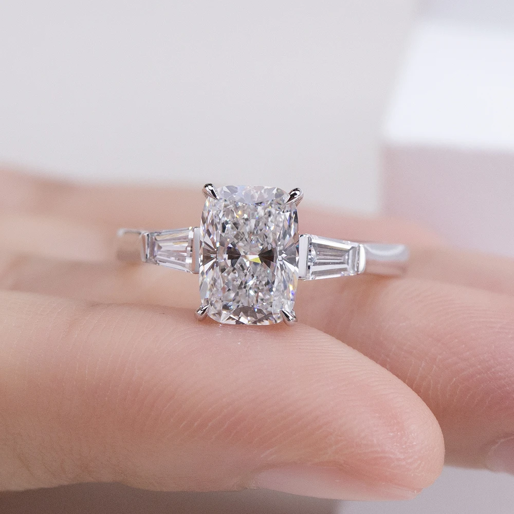 cushion cut moissanite ring, three stone engagement ring, baguette side stone ring, white gold plated ring USA, lab grown diamond alternative, luxury engagement ring for women, moissanite jewelry UK, classic bridal ring