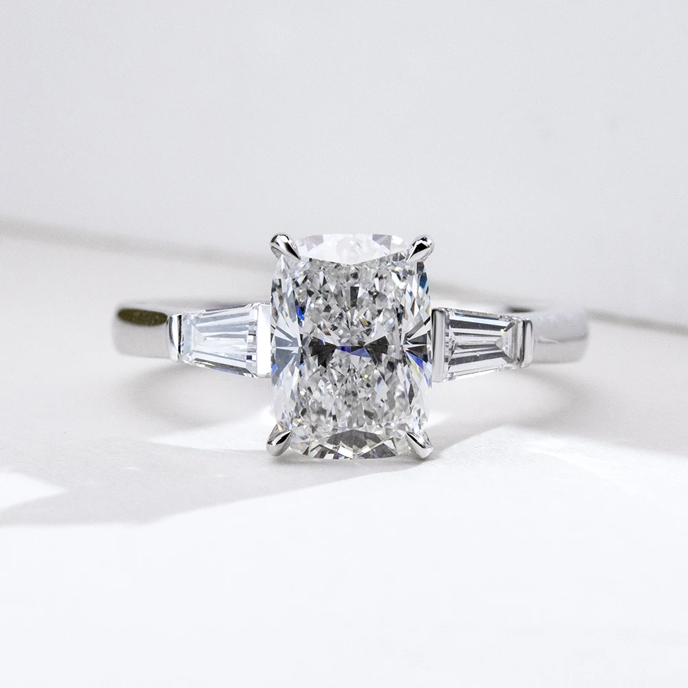 cushion cut moissanite ring, three stone engagement ring, baguette side stone ring, white gold plated ring USA, lab grown diamond alternative, luxury engagement ring for women, moissanite jewelry UK, classic bridal ring